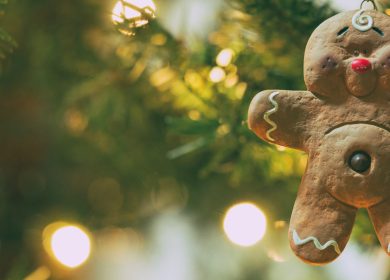Gingerbread cookie ornament on tree in the background