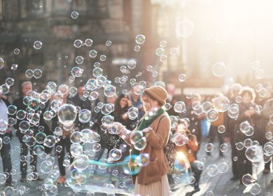 Woman standing in the middle of blown bubbles