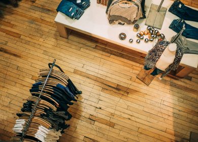 View from top of a shop with clothes on a rack and merchanised stand