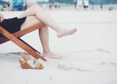 View of person on a lounge chair on the sand