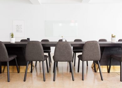 Table with chairs tucked in with white background