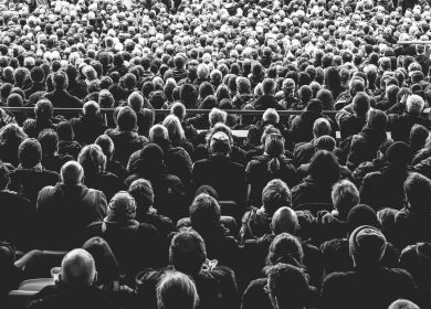 Crowd facing away from camera in black and white
