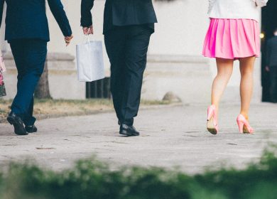 Three people's legs walking away from the camera