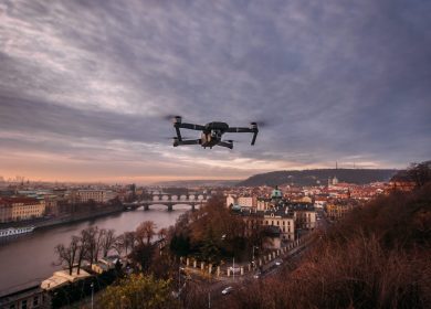 Drone over a hillside with a city in the background