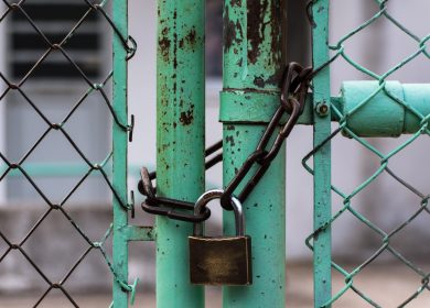 Chain locked on green poled chain link fence