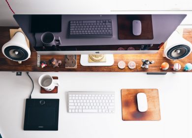 Top view of desk with computer, lamp, and other items on it