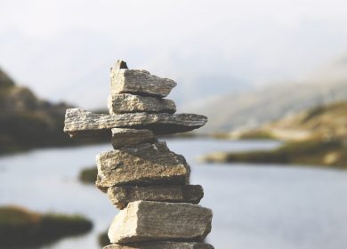 Rocks piled up with body of water in the background