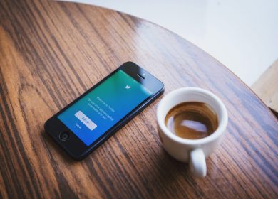 Smart phone and coffee cup on a table