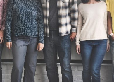 5 people standing next to each other