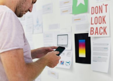 Man in front of a board with different notices on it