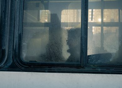 Shape of a person behind a cloudy window