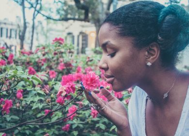 Woman smelling pink flowers